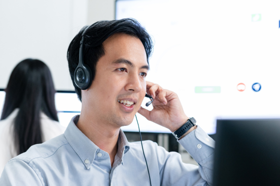 Customer support agent with headset talking on the phone
